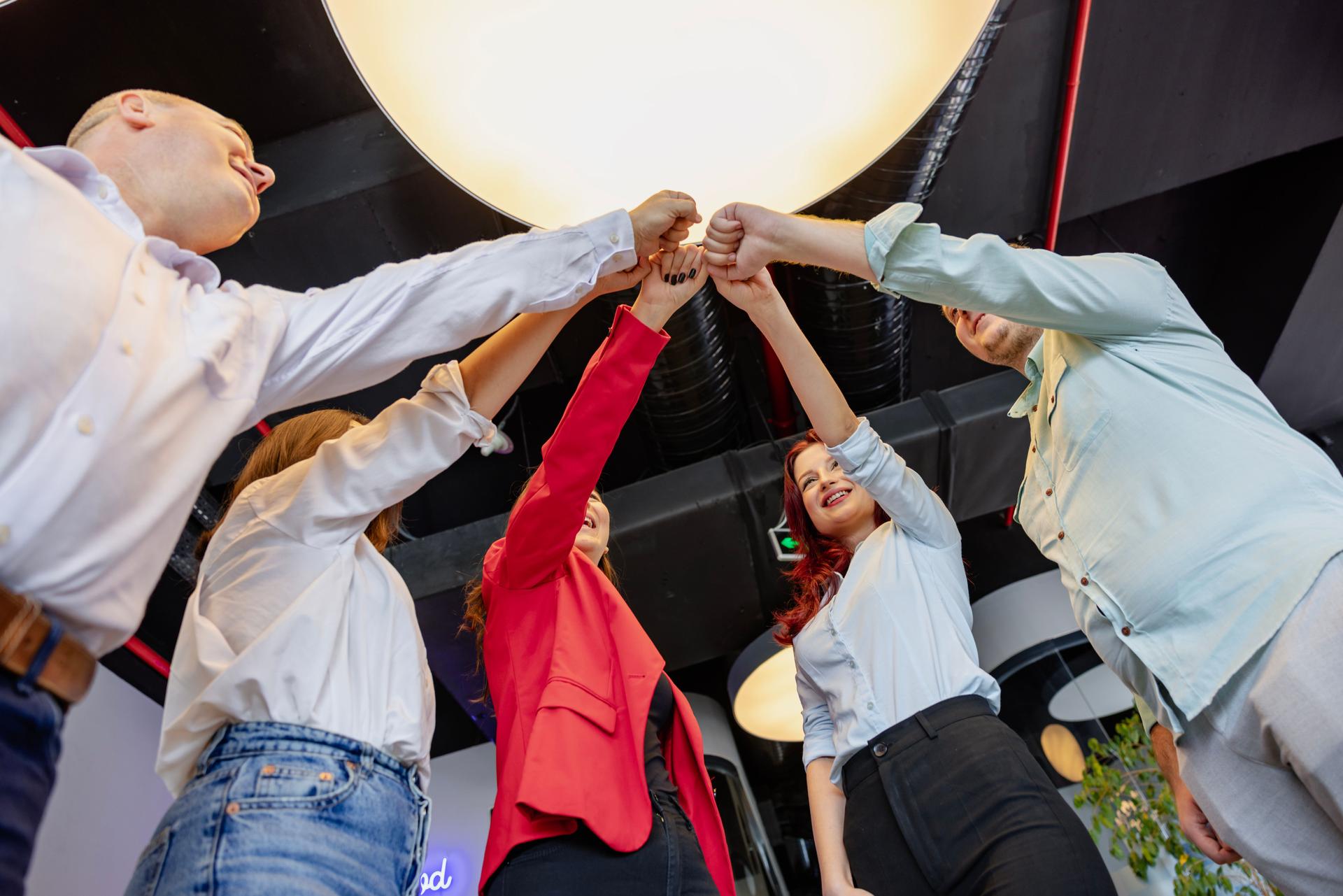 Business Colleagues Joining Hands in Unity, Fostering Team Spirit in a Creative Luxury Office Setting