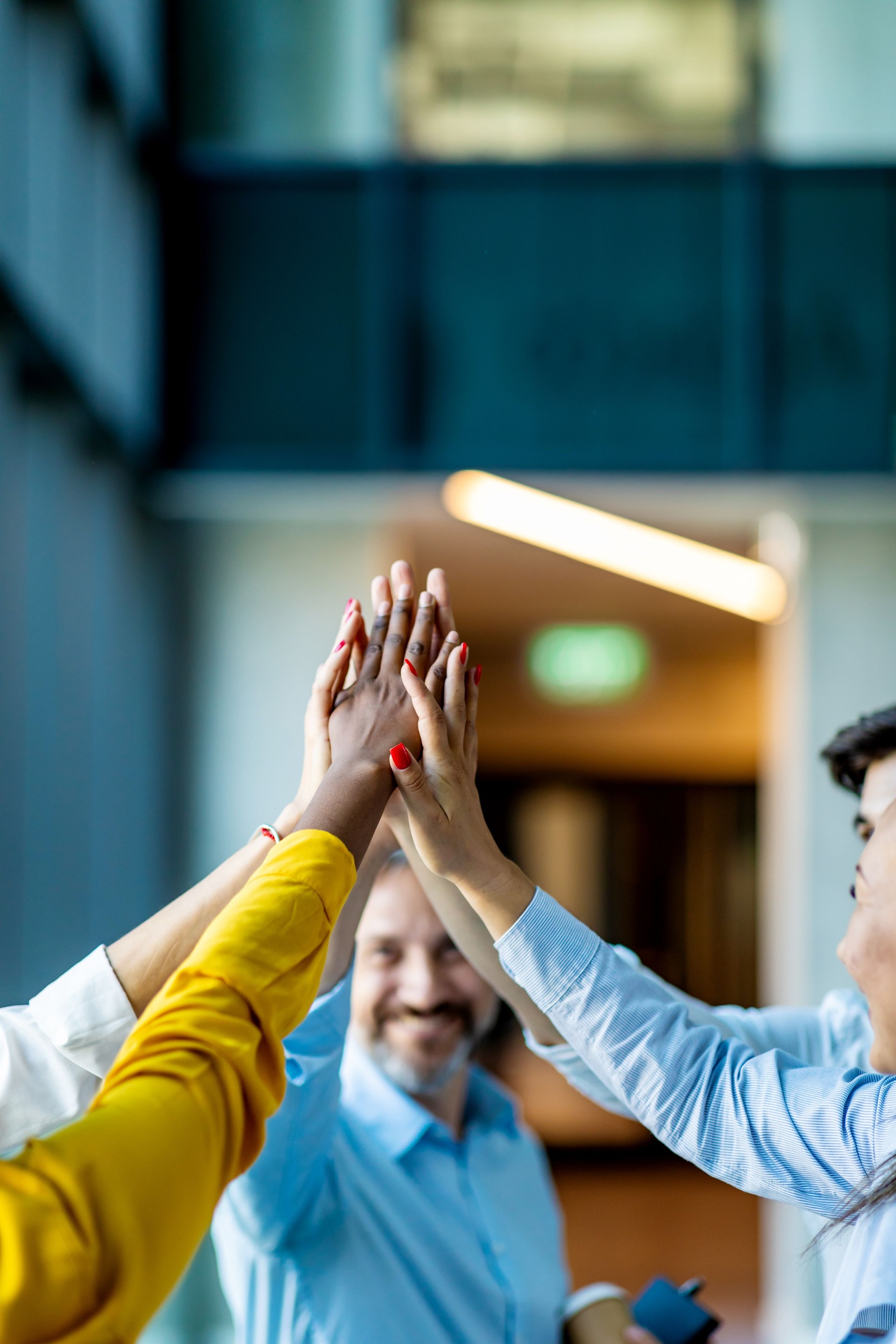 Cooperation and teamwork in business team with many hands stacked on a pile